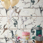 Balancing Act (Cream) wallpaper features colorful dancing monkeys and rabbits on a cream background