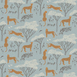 Our Serengeti wallpaper features brown cheetahs and birds scattered among white acacia trees on a dusty blue background, reflecting the powerful beauty of the vast plains. Designed by Julia Rothman and made in the USA.