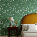 Chance (Juniper) wallpaper features intricately illustrated flowers and herbs in white and blue on a green background.