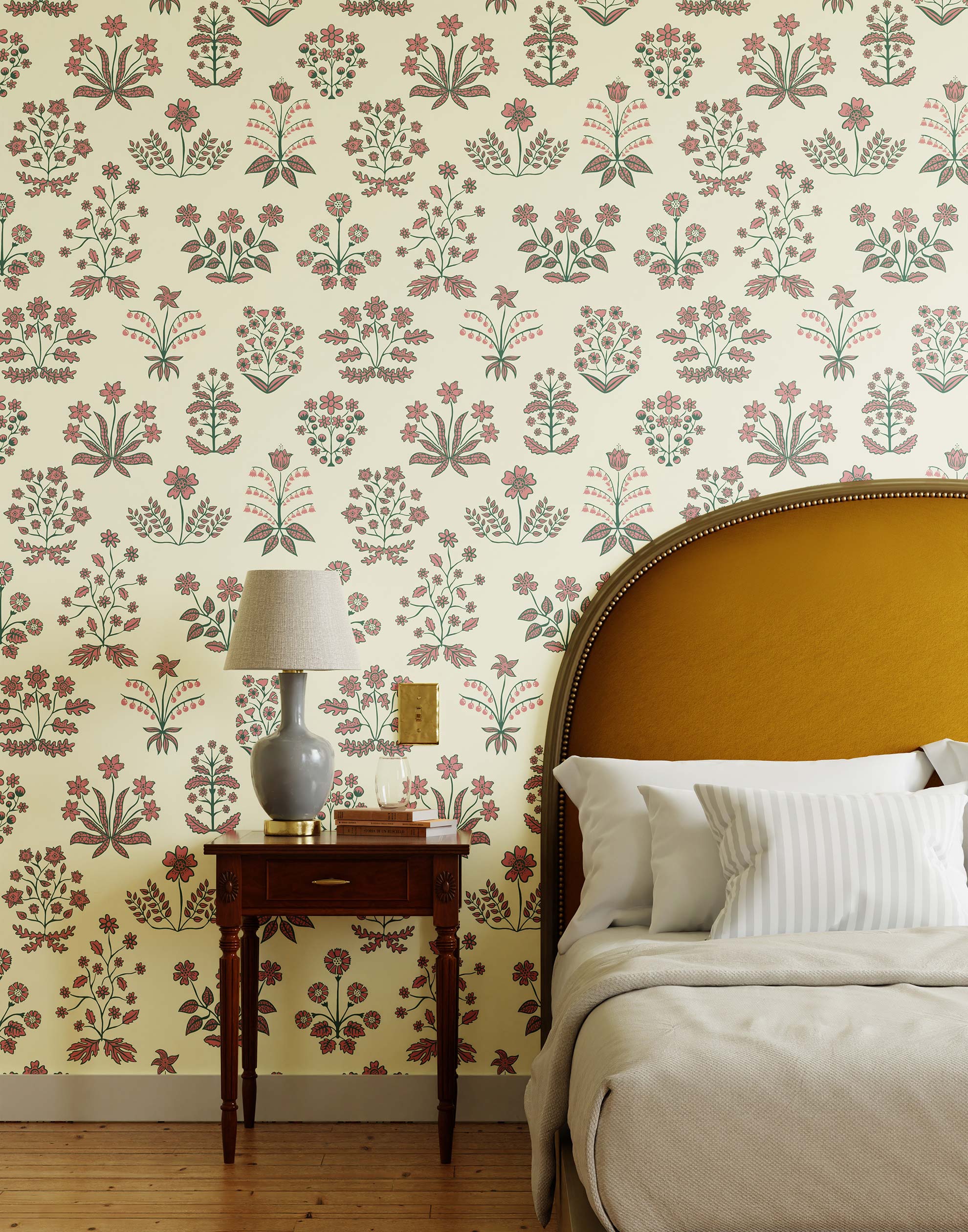 Chance (Punch) wallpaper features intricately illustrated flowers and herbs in green and pink on an off white background.