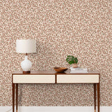 Olive Grove (Bellini) featuring a leafy vine motif in shades of rust and pink with green accents on an off white background | Schoolhouse x Hygge & West Wallpaper Collection