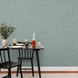 Alpine Garden Tonal (Mist) featuring hand drawn flowers in green on a dusty blue background | Schoolhouse x Hygge & West Wallpaper Collection
