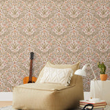 Inspired by the painted ceiling of Glinda and Elphaba's Shiz University dorm room in the movie Wicked, this wallpaper features colorful flowers and a crown on a soft pink background.
