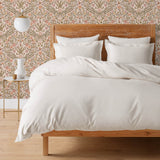 Inspired by the painted ceiling of Glinda and Elphaba's Shiz University dorm room in the movie Wicked, this wallpaper features colorful flowers and a crown on a soft pink background.