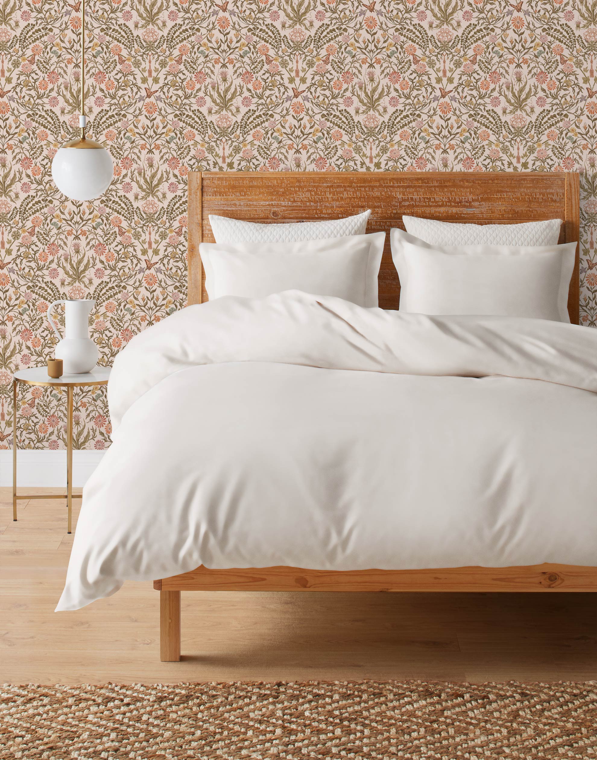 Inspired by the painted ceiling of Glinda and Elphaba's Shiz University dorm room in the movie Wicked, this wallpaper features colorful flowers and a crown on a soft pink background.