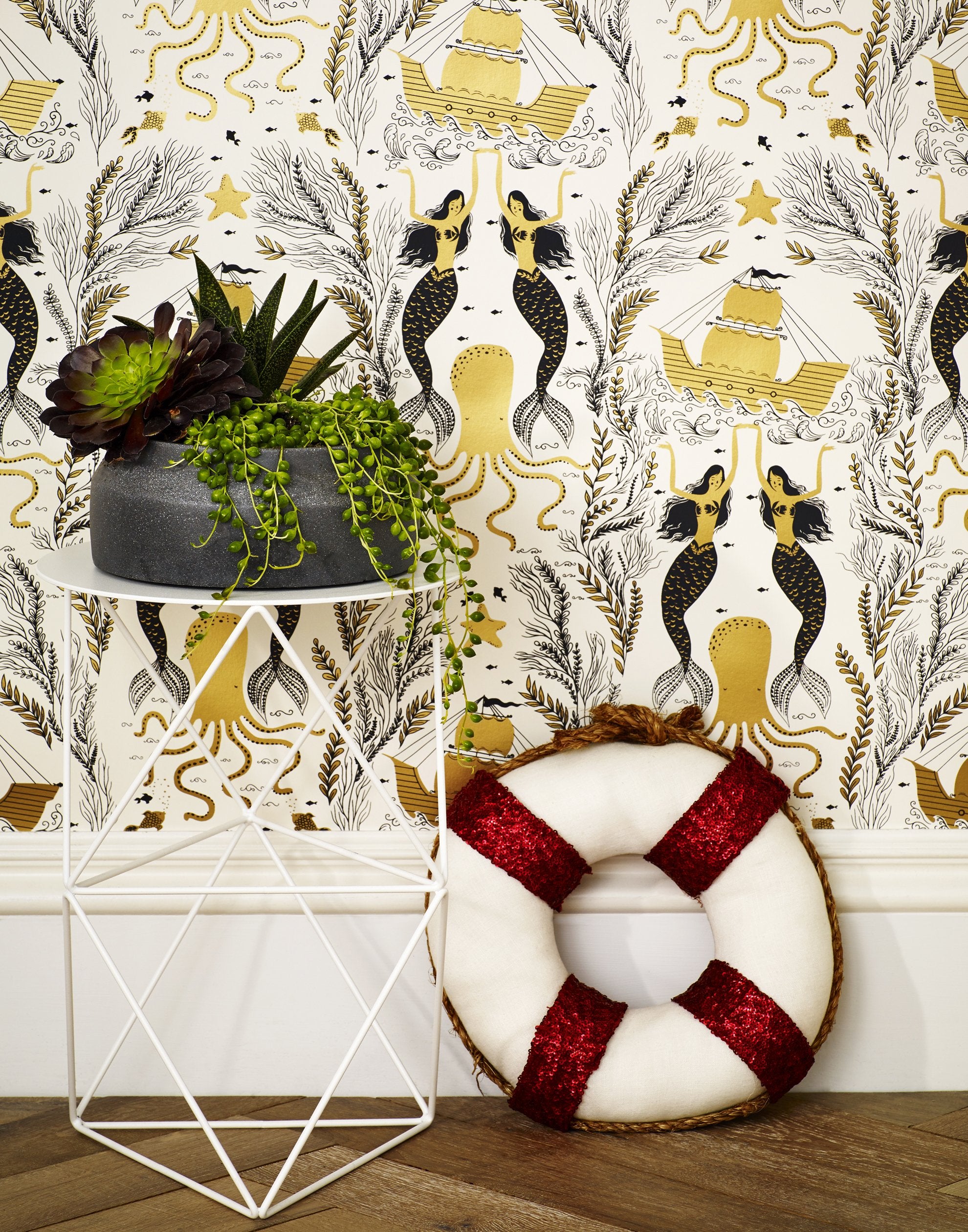 Mermaids (Gold) wallpaper | Mermaids, fish, octopi and ships float in this charming design | Gold and black artwork on an off white ground