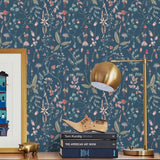 Sonoma (Indigo) wallpaper with green, mauve, coral and pink flowers and leaves on a blue background