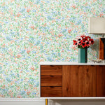 Summer (Vermillion) wallpaper features loose brushstrokes that capture the movement of wild flowers and grasses swaying in the breeze. Coral red, blue and green watercolored flora on a white background | Hygge & West
