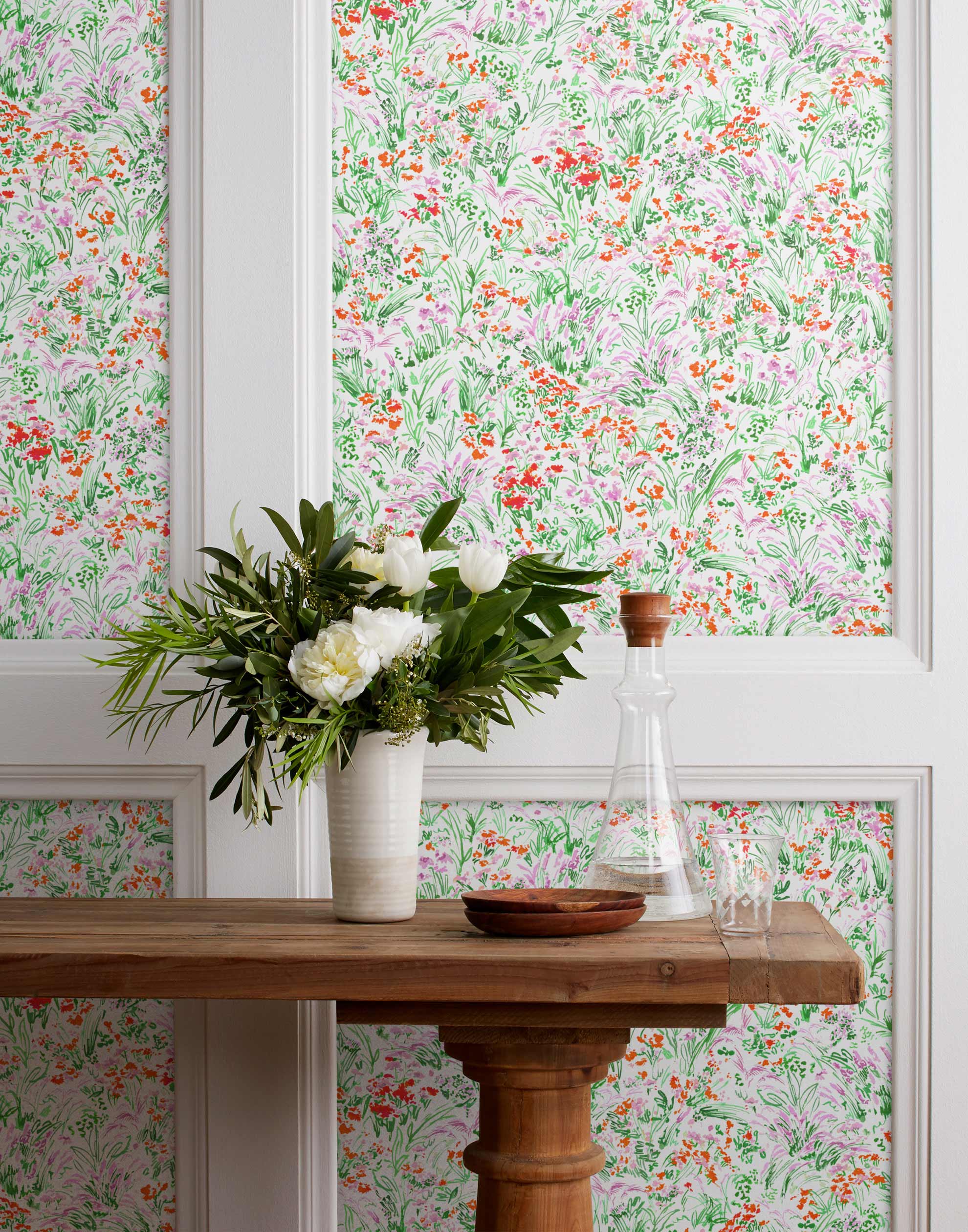 Summer (Poppy) wallpaper features loose brushstrokes that capture the movement of wild flowers and grasses swaying in the breeze. Bright red, lavender purple, and green watercolored flora on a white background | Hygge & West
