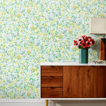 Summer (Sunshine) wallpaper features loose brushstrokes that capture the movement of wild flowers and grasses swaying in the breeze. Yellow, gold, light blue, and green watercolored flora on a white background | Hygge & West