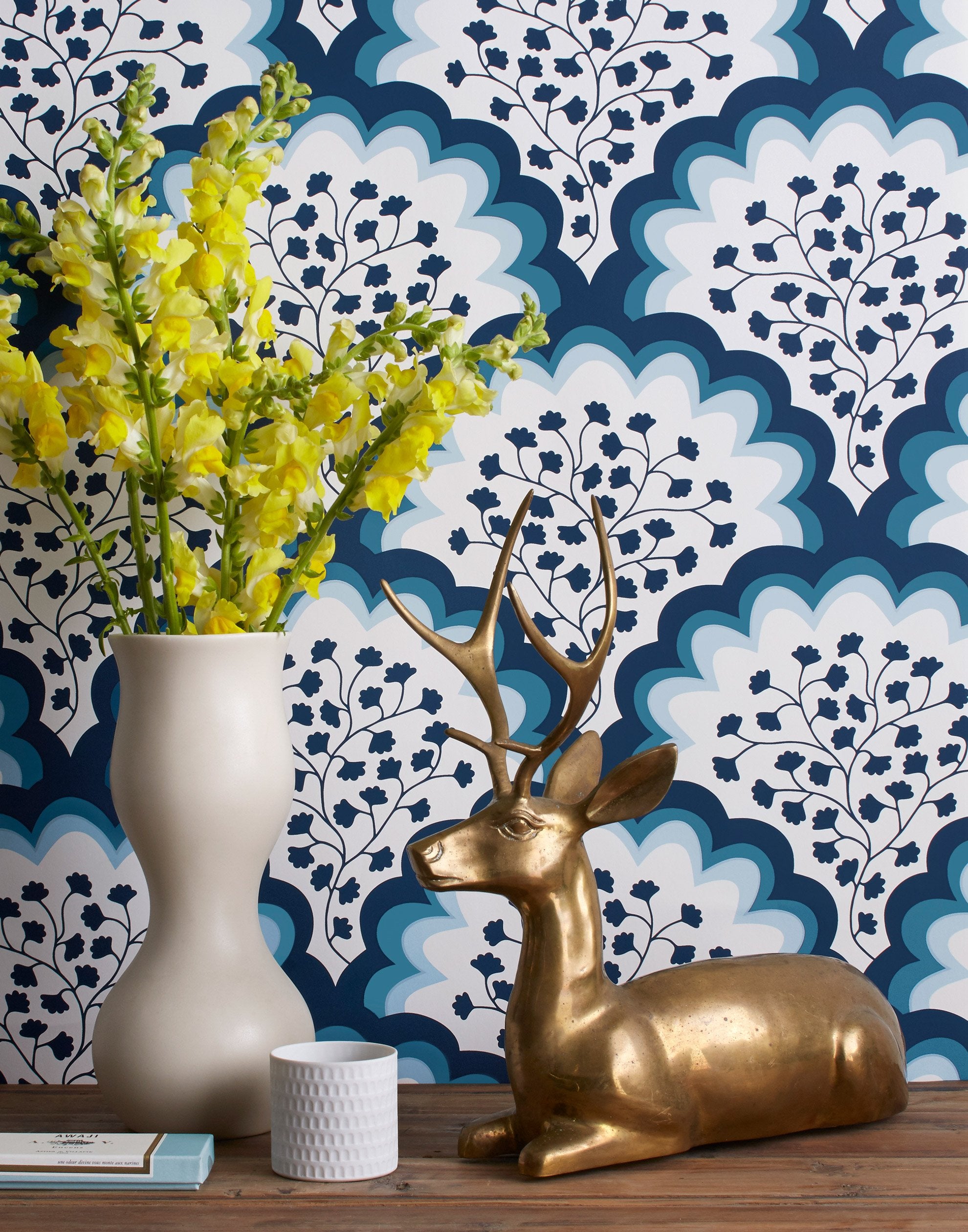 Angelina (Navy) wallpaper features a White background with graduated blue scallops and navy floral motif