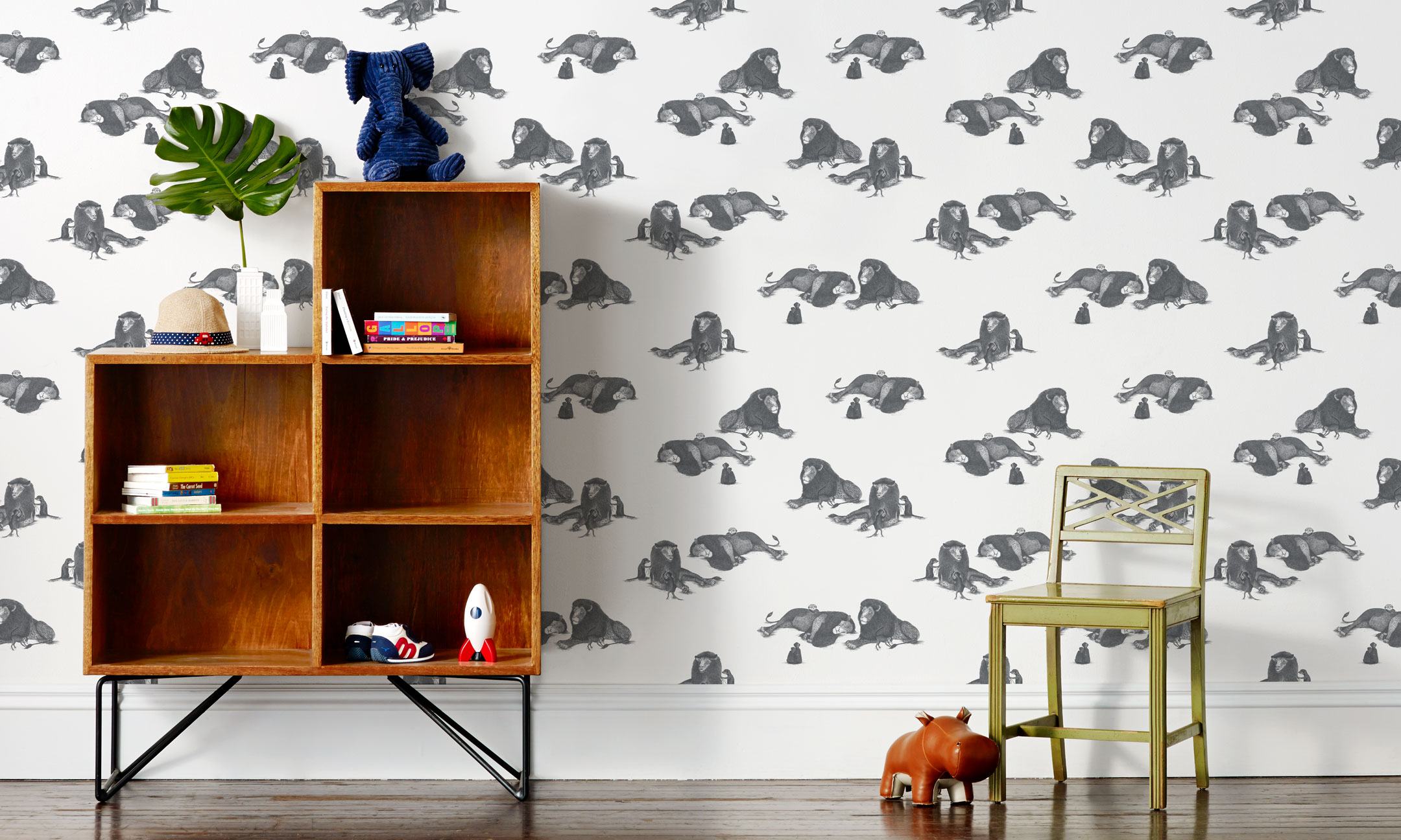 Mighty (Charcoal) wallpaper features gray lions and meerkats on a white background